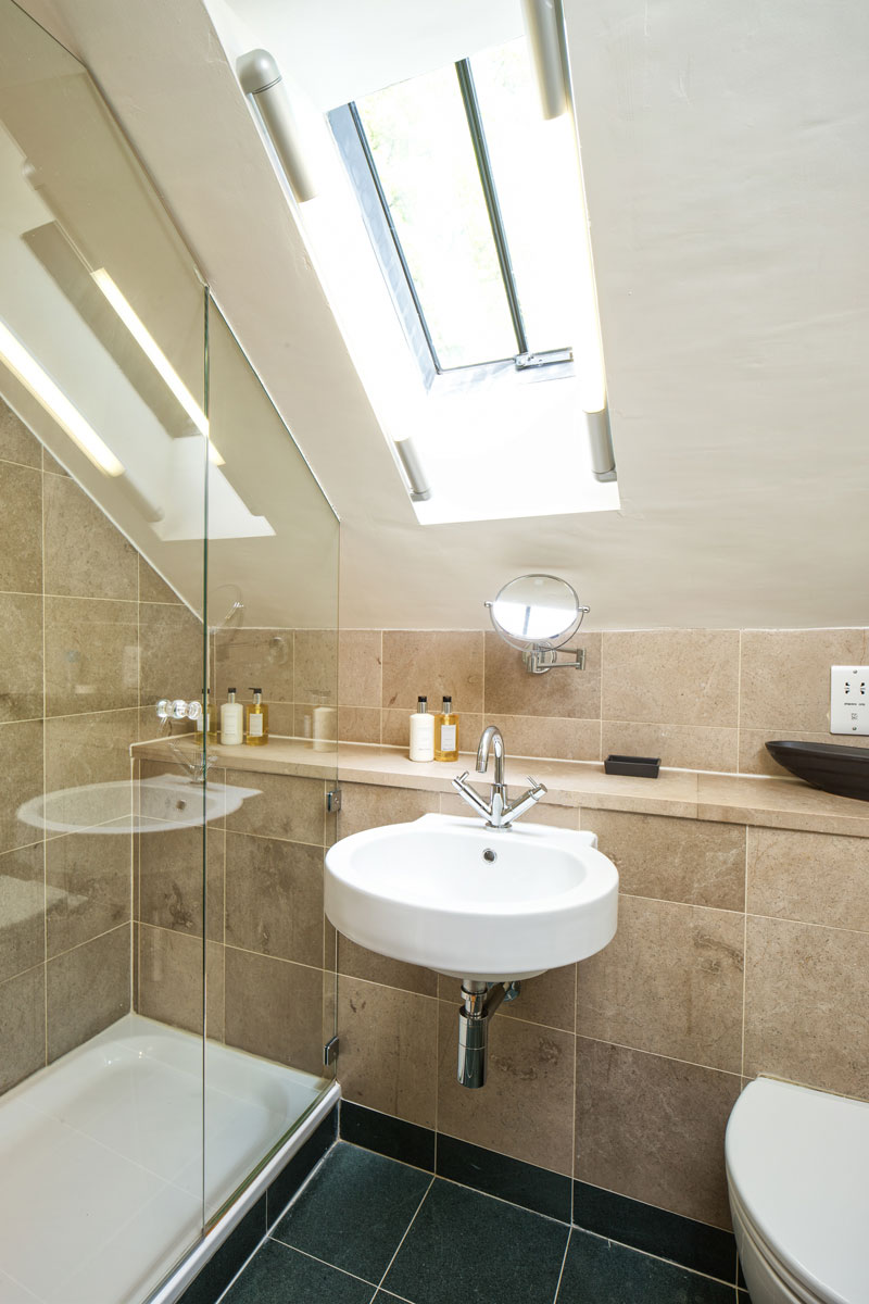 The second bedroom's ensuite features a shower, Buttermere slate and White Company toiletries