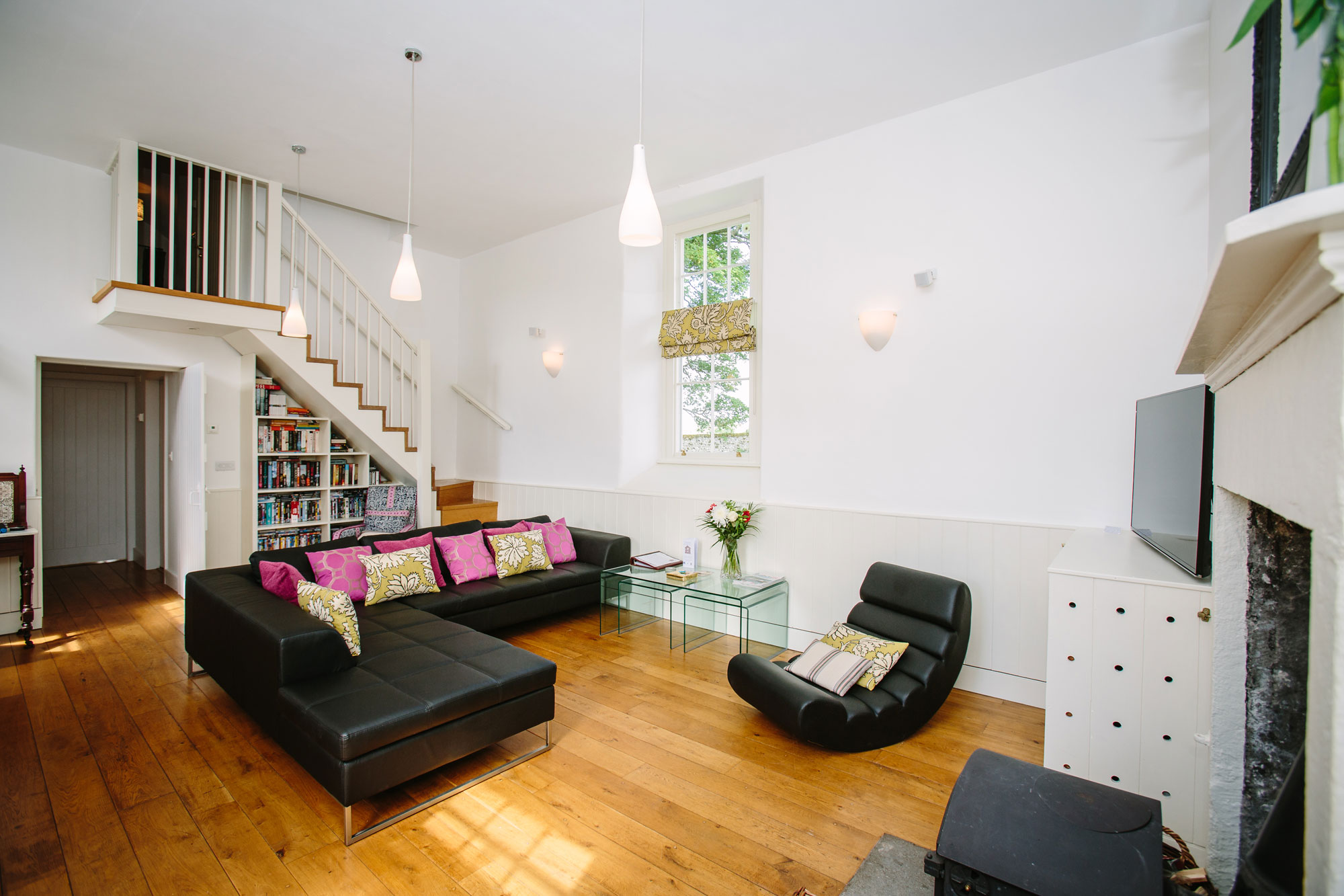 The main schoolroom with hand crafted staircase up to the second bedroom suite