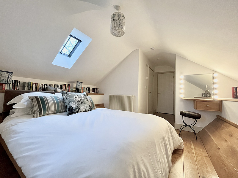 The second bedroom features a handmade bed